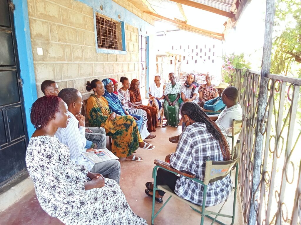 HERCS researchers Anne Khisa, PhD (Front left) and Jackson Wachira, PhD (Third right) conversing with a group of Community Health Promoters at Laisamis Mission Hospital, Marsabit. May 2025